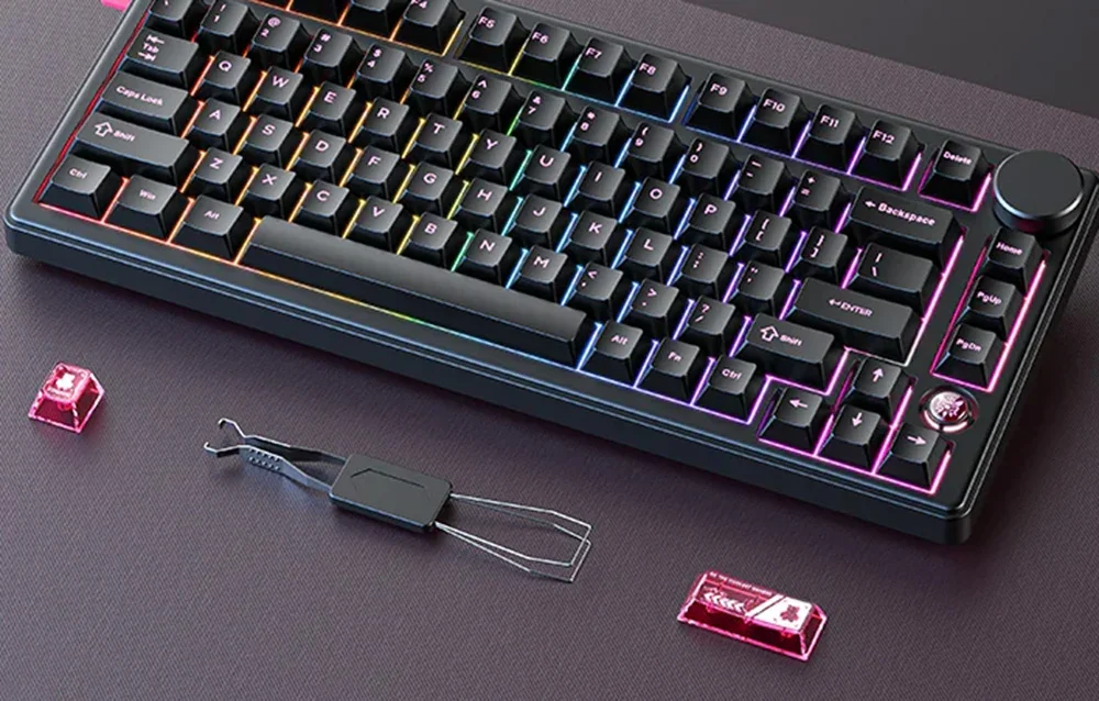 Black keyboard with 2 keys and switch removal tool on dark table