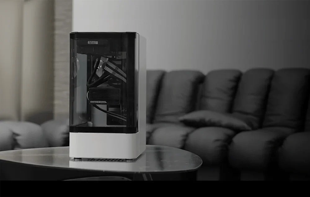 White-black computer case on living room table, black couch in the background